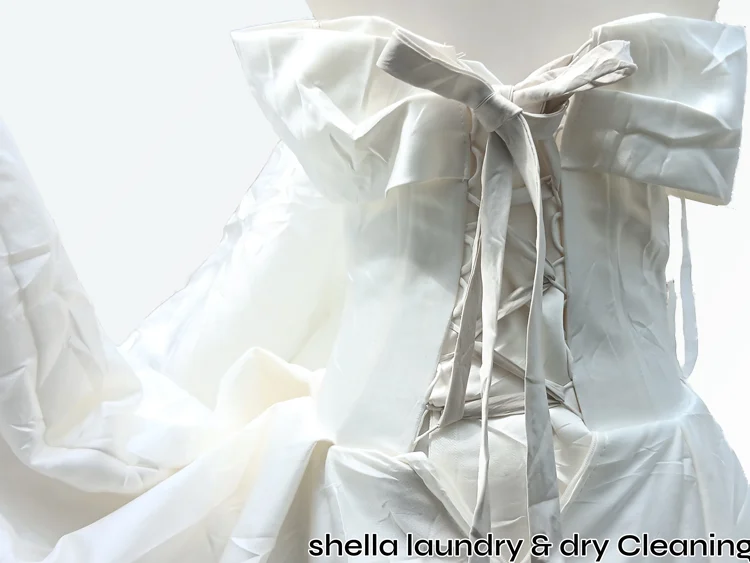 Wedding gown assessed before professional wet cleaning at Shella Laundry Surabaya