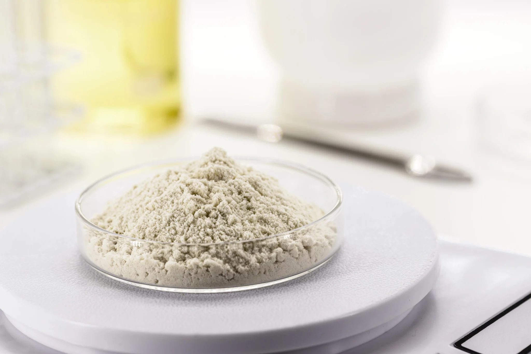 Bezact powder cleaning agent sample weighed out precisely on laboratory petri dish scale
